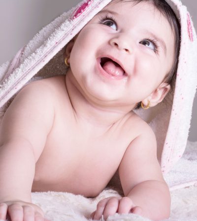 little-laughing-baby-girl-wearing-white-bath-towel-relaxing-bed-after-bath-shower